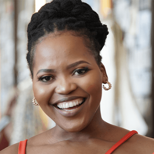 Children's book author Sihle’iSipho Nontshokweni in an orange top facing the camera.