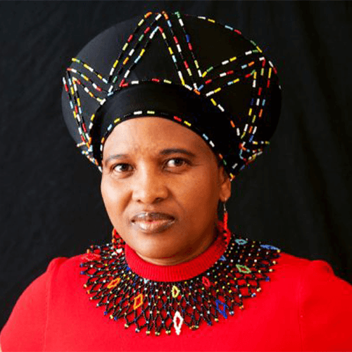 Dr Nomsa Mdlalose, author of Naughty Nogwaja, in a red shirt and traditional Zulu headwear and beads.