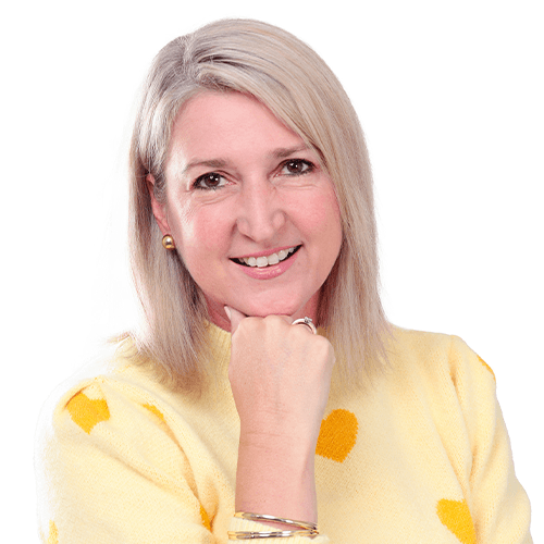 Lori Ann Preston, author of Trevor the Hero, looking into the camera with her chin placed on her hand.